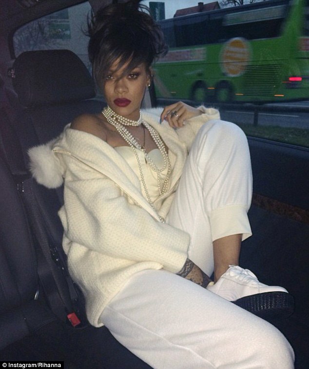 The face that launched a thousand purchases! Rihanna posted this picture to Instagram - in which she is wearing white Puma sneakers - this morning with the caption 'Such a f****n' lady'